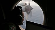 FILE - Flight officer Rayan Gharazeddine scans the water in the southern Indian Ocean off Australia from a Royal Australian Air Force AP-3C Orion during a search.