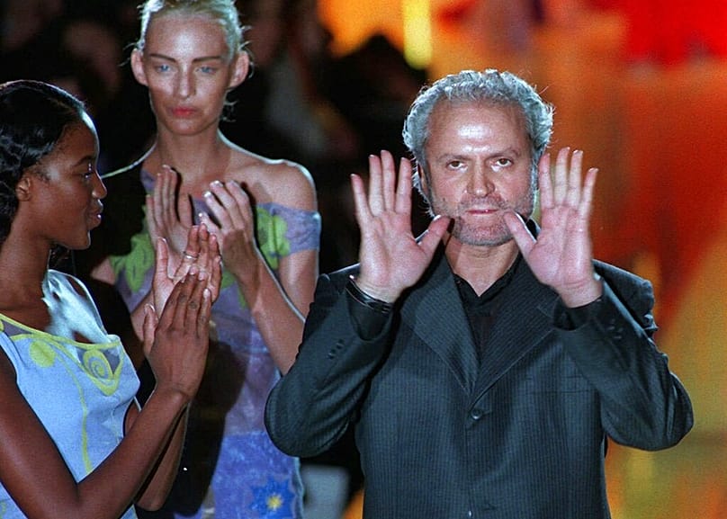 FILE - Italian designer Gianni Versace gestures while being applauded by models including Naomi Campbell in Paris 18 January 1997 at the end of his 1997 Spring-Summer show.