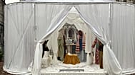 A Nativity scene containing characters with cloth faces, by artist Victoria-Maria Geyer, is displayed in a white tent in Brussels, 1 December 2025
