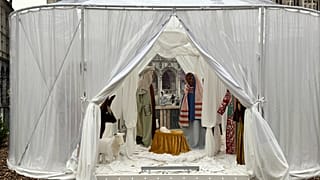 A Nativity scene containing characters with cloth faces, by artist Victoria-Maria Geyer, is displayed in a white tent in Brussels, 1 December 2025