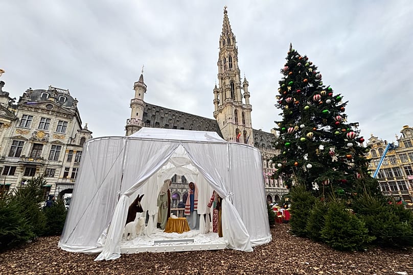 A Nativity scene containing characters with cloth faces, by artist Victoria-Maria Geyer, is displayed in a white tent in Brussels, 1 December 2025