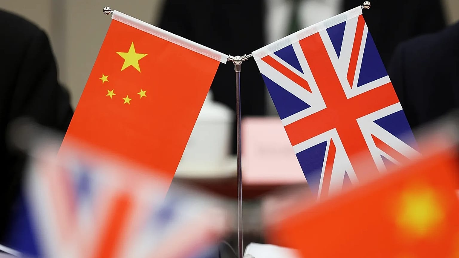 Flags of China and the Union Jack stand during the China-UK Energy Dialogue in Beijing, 17 March, 2025