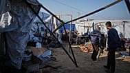 Displaced Palestinians inspect the damage after an Israeli army strike on their tent camp in Khan Younis, 4 December, 2025