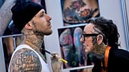 A woman works on a client during the Gods of Ink Tattoo Convention with 400 international tattoo artists in Frankfurt, Germany.