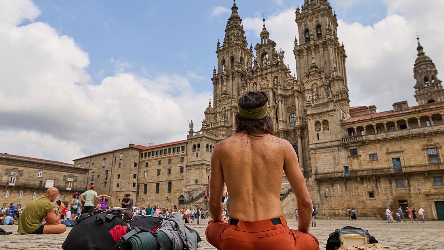 Peregrinos descansan ante la Catedral de Santiago de Compostela