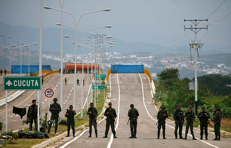 FILE: Venezuelan Bolivarian Army soldiers stand guard at the Tienditas International Bridge that links Colombia and Venezuela, near Urena, Venezuela, 8 February 2019