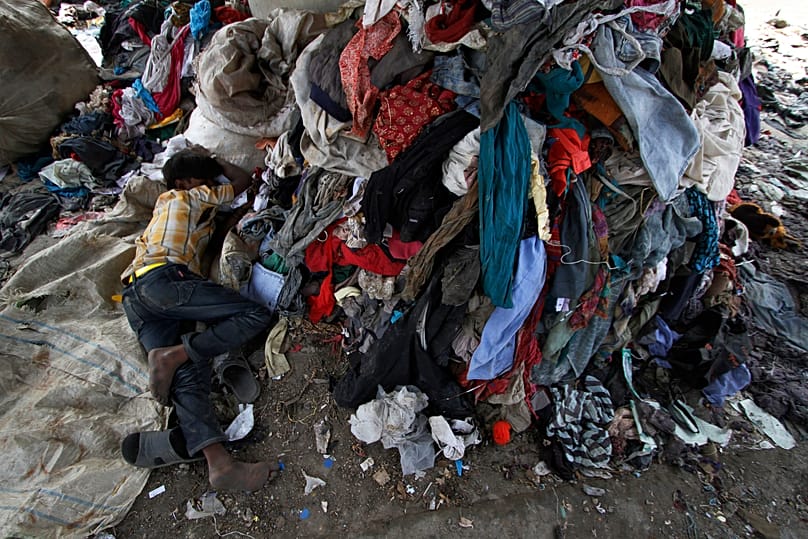 A Nepalese man sleeps at a junkyard in Kathmandu, 17 October, 2011
