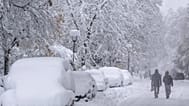 People walk following a heavy snowfall in Munich, Germany Saturday, Dec. 2, 2023