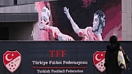 A woman walks outside the Turkish Football Federation headquarters in Istanbul, 12 November, 2025