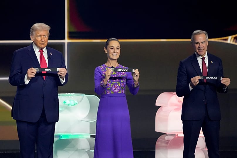 Donald Trump, Claudia Sheinbaum and Mark Carney holds their countries' name during the draw for the 2026 World Cup in Washington, 5 December, 2025