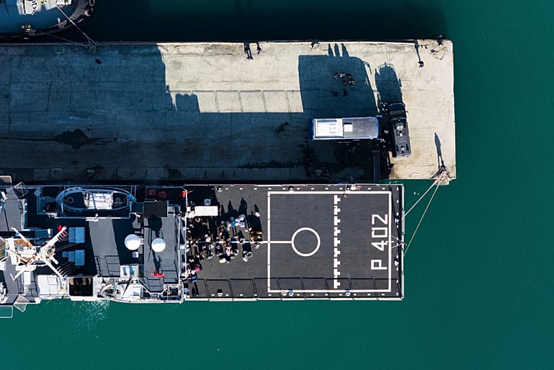 Migrants waiting to disembark an Italian navy ship to go to an Italian-run migration detention centre in Albania, 11 April, 2025