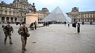 Soldiers patrol as people queue to try to enter the Louvre museum in Paris, 20 October, 2025 