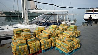  Bales of cocaine weighting some 5,2 tons and a seized yacht are displayed for the media at a Portuguese Navy base in Almada, south of Lisbon, on Oct. 18, 2021. 
