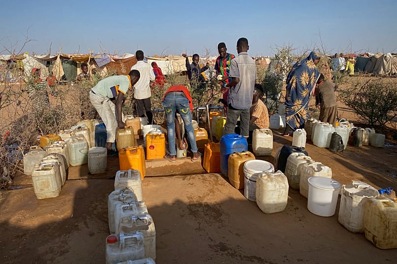 Sudanese men who fled el-Fasher collect water at a camp in Tawila, 1 November, 2025