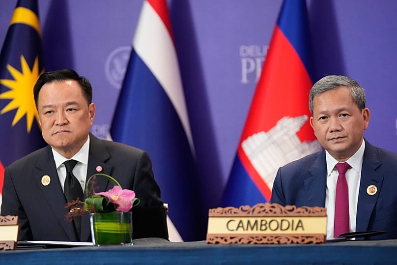 FILE - Cambodian Prime Minister Hun Manet, right, and Thailand's Prime Minister Anutin Charnvirakul, left, react during a signing ceremony on the sidelines of the ASEAN Summit