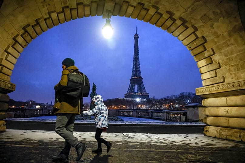 A child goes to school in front of the Eiffel Tower in Paris, 18 January, 2024
