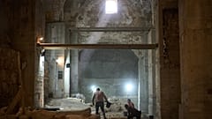 Workers from the Israel Antiquities Authority clean a section of an excavation site where, according to the institution, a city wall from the Hasmonean period