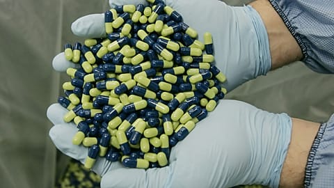 A worker at Eli Lilly and Company examines Cymbalta 60mg pills, a popular antidepressant medication.