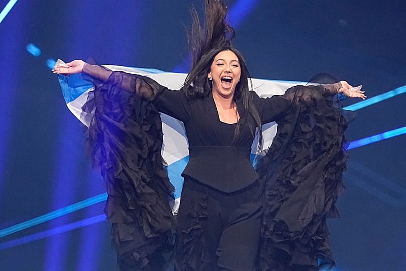 Yuval Raphael from Israel holds her country’s flag onstage during the Grand Final of the 69th Eurovision Song Contest in Basel, 17 May, 2025