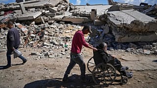 A man pushes his father to Shifa hospital in Gaza City for dialysis, 14 April, 2025