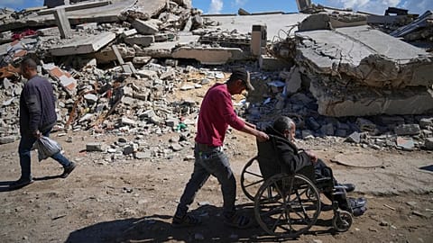 A man pushes his father to Shifa hospital in Gaza City for dialysis, 14 April, 2025