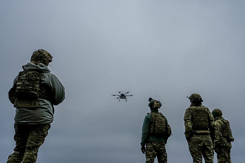 A Ukrainian drone operator from the Kraken 1654 unit, callsign Imla, left, flies a Vampire drone as other soldiers watch in Kharkiv region, Ukraine.