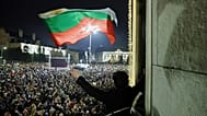 A student waves a Bulgarian flag as tens of thousands of Bulgarians gather in Sofia's central square, demanding the government's resignation, Sofia, 10 December 2025