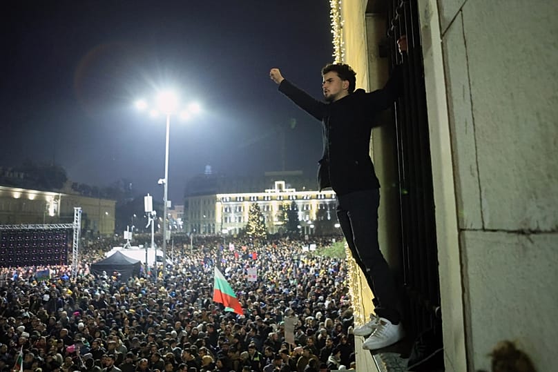 A protester raise his fist as a crowd of tens of thousands of Bulgarians filled Sofia's central square, 10 December, 2025