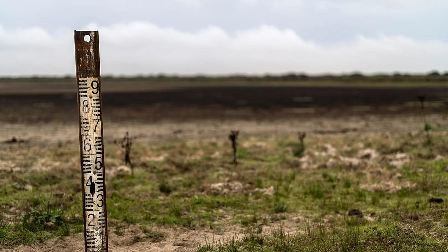 A water meter stands in a dry wetland in Donana natural park, southwest Spain.