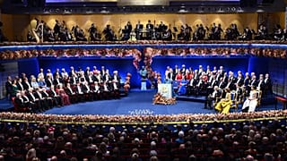 Overview of the podium with the Nobel laureates and the royal family during the Nobel Prize ceremony at the Stockholm Concert Hall, Sweden, Wednesday Dec. 10, 2025