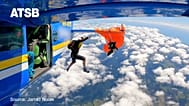Skydiver dangles 4,500 metres in the air after parachute snags on plane tail 