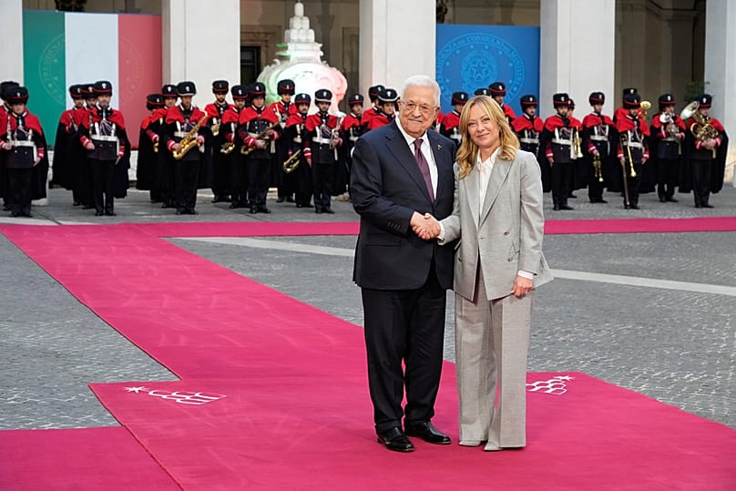 Palestinian President Mahmoud Abbas and Italian Premier Giorgia Meloni, right, pose for photographers during their meeting at Palazzo Chigi in Rome, 12 December 2025.