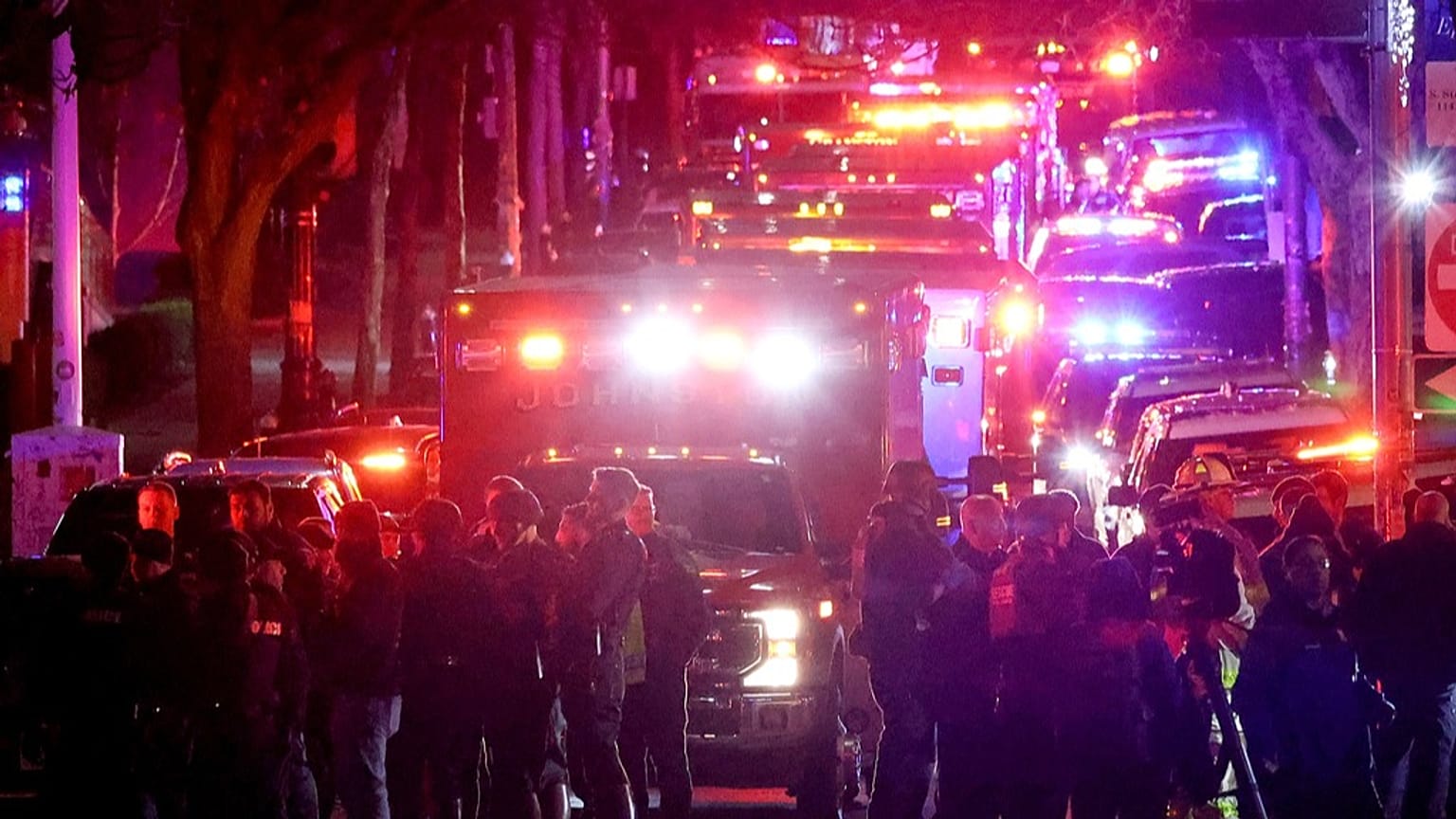 Emergency personnel gather on Waterman Street at Brown University in Providence, R.I., on Saturday, Dec. 13, 2025, during the investigation of a shooting