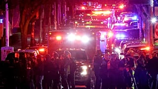 Emergency personnel gather on Waterman Street at Brown University in Providence, R.I., on Saturday, Dec. 13, 2025, during the investigation of a shooting