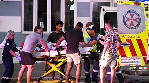 Emergency workers transport a person on a stretcher after a reported shooting at Bondi Beach in Sydney