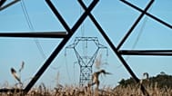 Electricity poles are seen in the countryside outside Lyon, central France, Monday, Sept. 12, 2022.