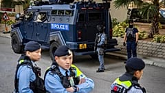 Armed police stand guard outside the courtroom following the verdict for Hong Kong activist publisher Jimmy Lai's national security trial in Hong Kong, 15 December 2025