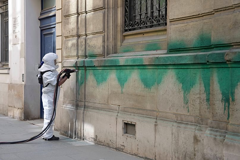 A worker cleans the Synagogue des Tournelles that had been defaced with green paint in Paris, 31 May, 2025 