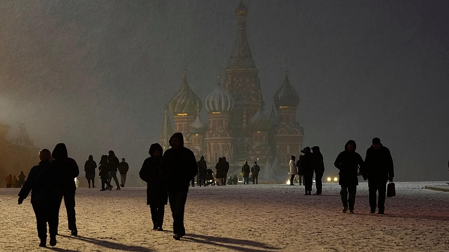 Snow falls on people walking through Red Square in Moscow, 8 April, 2025