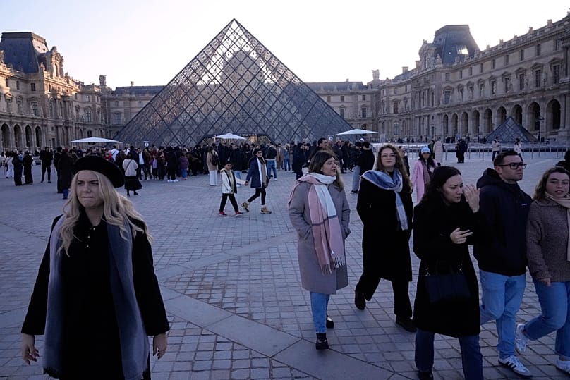 Visitors leave the Louvre museum shortly before workers voted to strike for the day over working conditions and other complaints, 15 December, 2025 