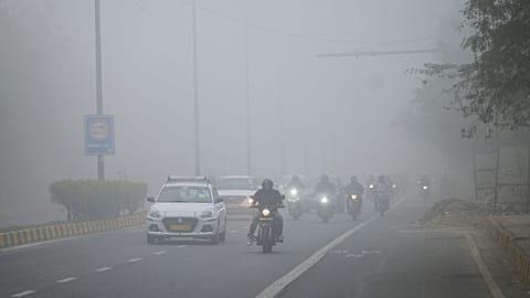 Traffic moves through dense smog in the morning in New Delhi, India, Monday, Dec. 15, 2025. 