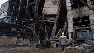 File - A worker walks in front of a production hall after a recent Russian missile attack at DTEK's power plant in Ukraine, on Wednesday, Dec. 10, 2025. 
