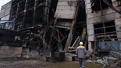 File - A worker walks in front of a production hall after a recent Russian missile attack at DTEK's power plant in Ukraine, on Wednesday, Dec. 10, 2025. 