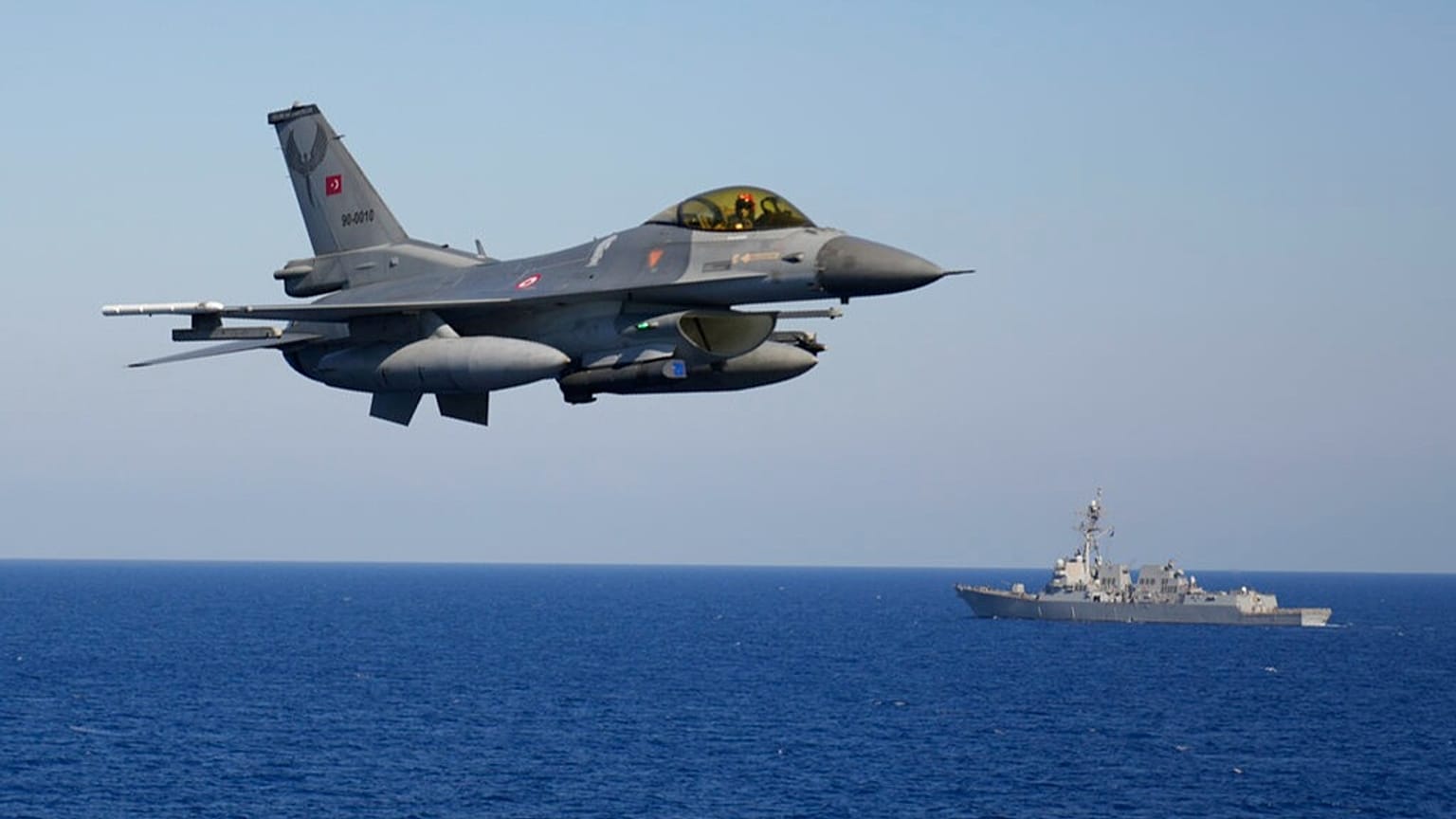 FILE: A Turkish F16 fighter jet flies over naval ships during an annual NATO naval exercise on Turkey's western coast on the Mediterranean, Thursday, Sept. 15, 2022.