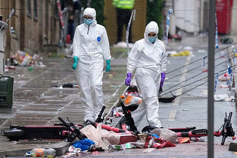 Forensic officers examine the site where a British man drove a minivan into a crowd of football fans in Liverpool, 27 May, 2025