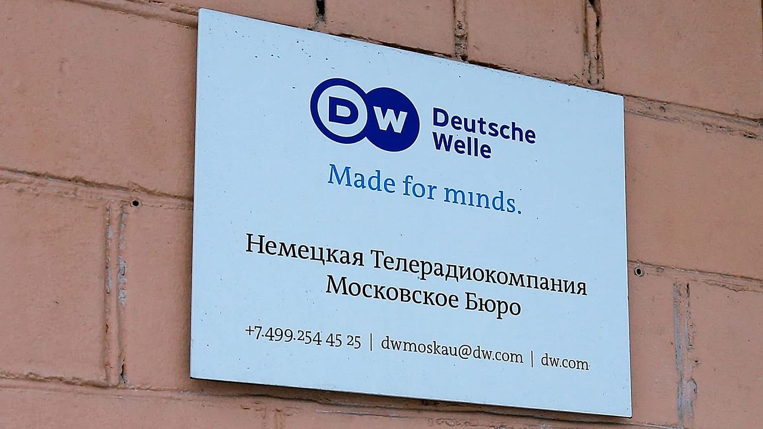 The sign of the Moscow office of German public broadcaster Deutsche Welle is seen on the wall of an apartment building in Moscow, 4 February, 2022