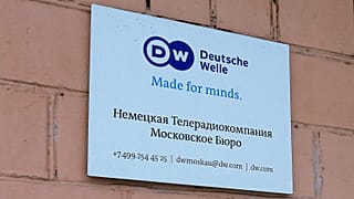The sign of the Moscow office of German public broadcaster Deutsche Welle is seen on the wall of an apartment building in Moscow, 4 February, 2022