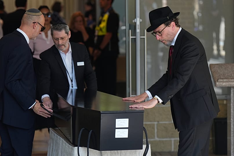 The coffin of Rabbi Yaakov Levitan, a victim in the Bondi Beach mass shooting, is carried into a chapel for his funeral in Sydney, Wednesday, Dec. 17, 2025.
