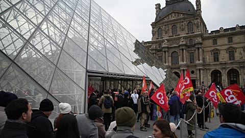 Unions demonstrate at the entrance to the Louvre museum after employees voted to extend strike action 