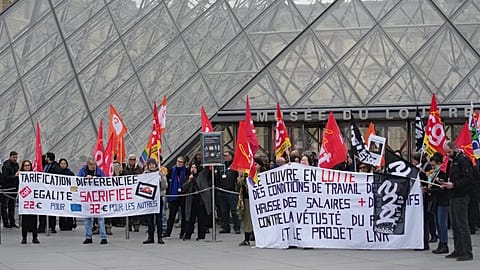 Unionists display a banner and union flags outside the Louvre museum in Paris, 17 December, 2025 